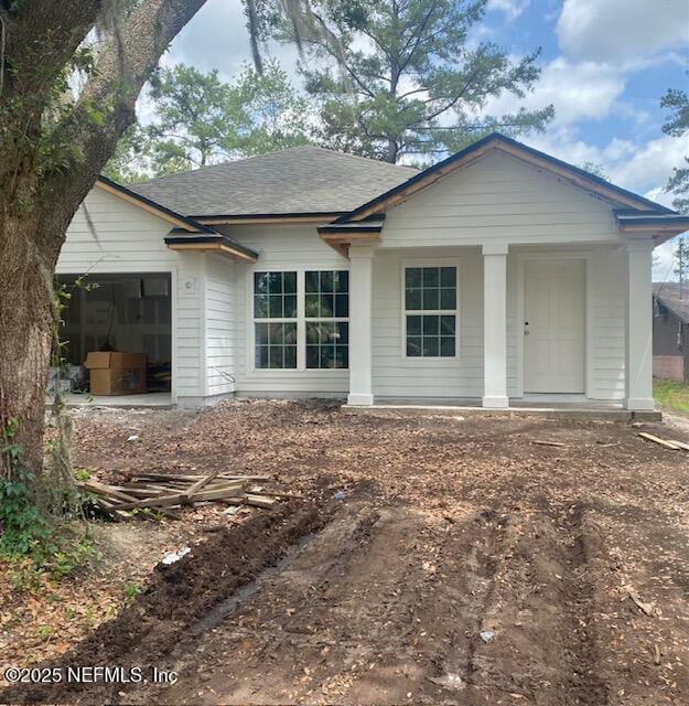 9027 Noroad, Jacksonville, FL 32210 - rear view of property with an attached garage and roof with shingles
