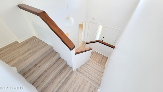 9360 Craven Rd Unit 703, Jacksonville, FL 32257 - staircase featuring wood finished floors and a high ceiling