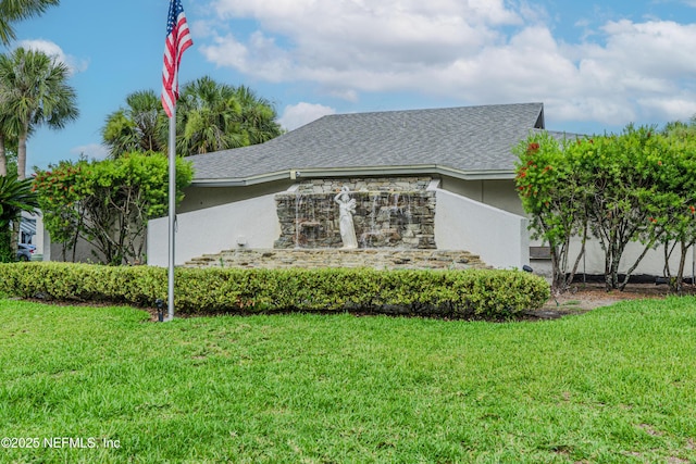 9360 Craven Rd Unit 703, Jacksonville, FL 32257 - view of property exterior with a lawn, stucco siding, and roof with shingles