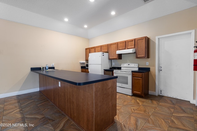 9360 Craven Rd Unit 703, Jacksonville, FL 32257 - kitchen featuring white appliances, under cabinet range hood, dark countertops, a peninsula, and recessed lighting