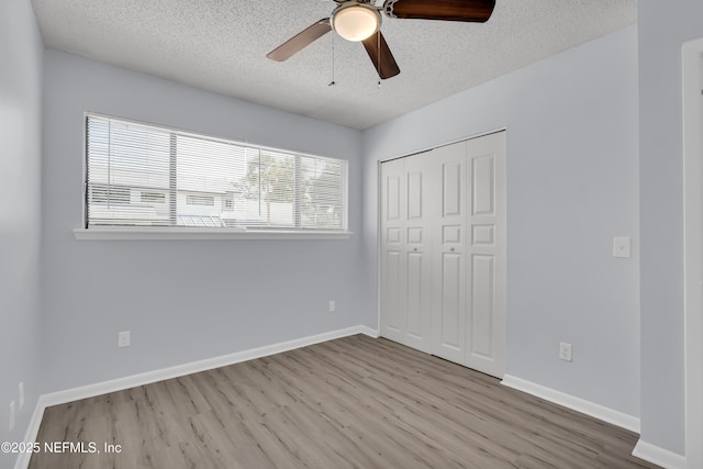 9360 Craven Rd Unit 703, Jacksonville, FL 32257 - unfurnished bedroom featuring wood finished floors, a textured ceiling, a closet, and ceiling fan