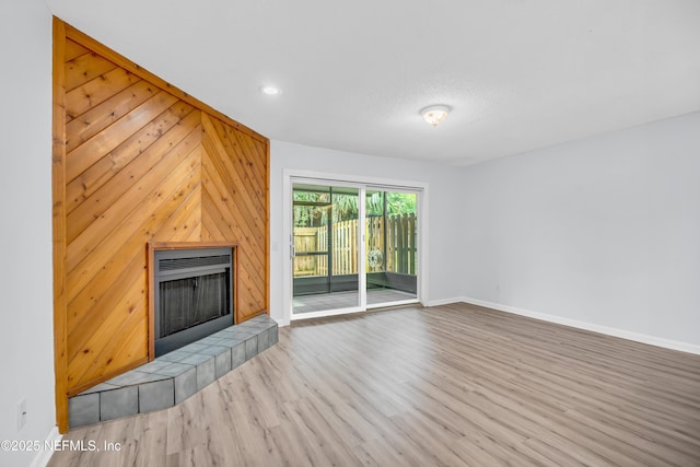 9360 Craven Rd Unit 703, Jacksonville, FL 32257 - unfurnished living room featuring wood finished floors, a fireplace, wooden walls, and recessed lighting