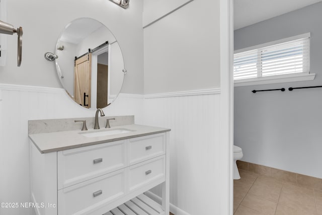 9360 Craven Rd Unit 703, Jacksonville, FL 32257 - bathroom featuring a wainscoted wall, vanity, and tile patterned floors
