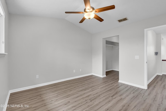 9360 Craven Rd Unit 703, Jacksonville, FL 32257 - unfurnished bedroom with wood finished floors, a closet, a spacious closet, vaulted ceiling, and a ceiling fan