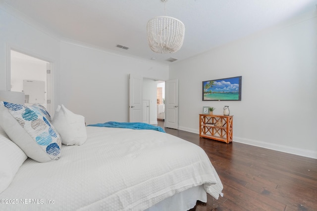 97082 Harbor Concourse Cir, Fernandina Beach, FL 32034 - bedroom with a chandelier, dark wood-style flooring, and ornamental molding