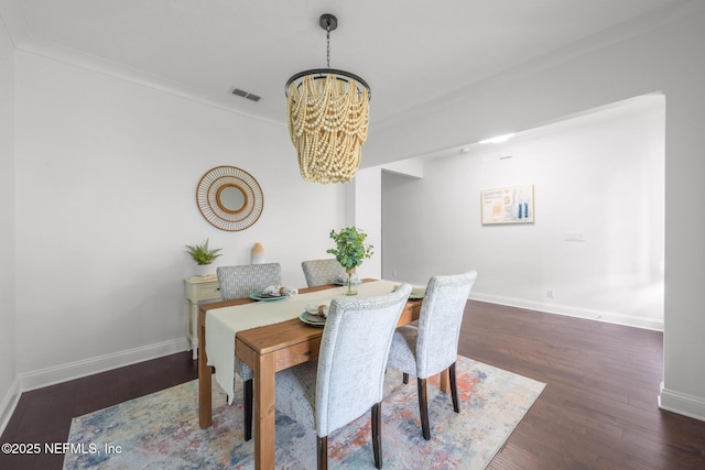 97082 Harbor Concourse Cir, Fernandina Beach, FL 32034 - dining area featuring a chandelier, wood finished floors, and ornamental molding