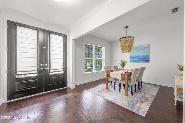 97082 Harbor Concourse Cir, Fernandina Beach, FL 32034 - dining space with french doors, wood finished floors, and a chandelier