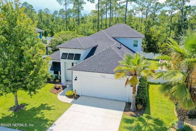 97082 Harbor Concourse Cir, Fernandina Beach, FL 32034 - view of front of property with roof with shingles, a garage, concrete driveway, and a front yard
