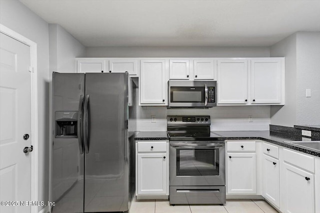 8550 Argyle Business Loop Unit 406, Jacksonville, FL 32244 - kitchen featuring appliances with stainless steel finishes, white cabinetry, and light tile patterned floors