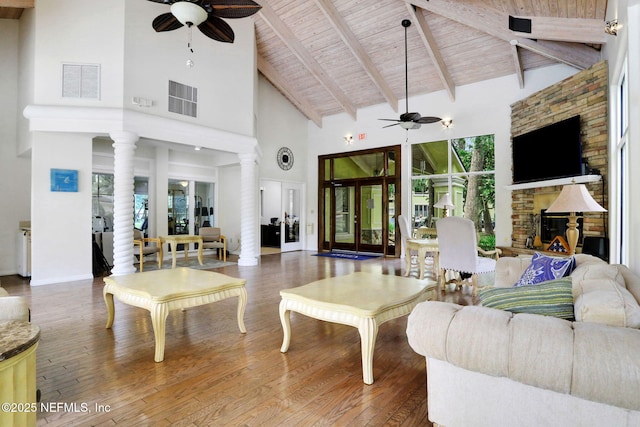1800 The Greens Way Unit 605, Jacksonville Beach, FL 32250 - living room featuring a ceiling fan, high vaulted ceiling, a wooden ceiling with exposed beams, decorative columns, and wood finished floors