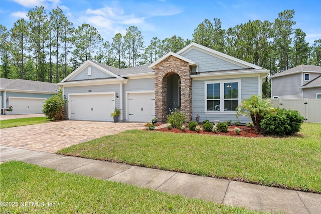 3024 Las Calinas Blvd, Saint Augustine, FL 32095 - view of front of home with decorative driveway, an attached garage, and stone siding