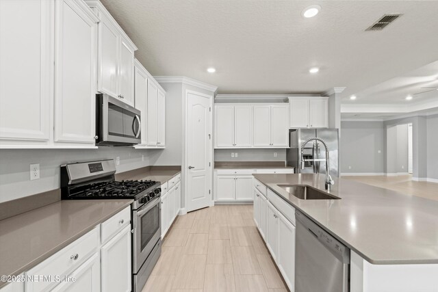 3024 Las Calinas Blvd, Saint Augustine, FL 32095 - kitchen featuring stainless steel appliances, recessed lighting, white cabinetry, and an island with sink