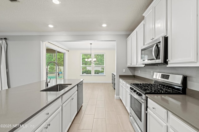 3024 Las Calinas Blvd, Saint Augustine, FL 32095 - kitchen featuring stainless steel appliances, a chandelier, ornamental molding, white cabinets, and recessed lighting