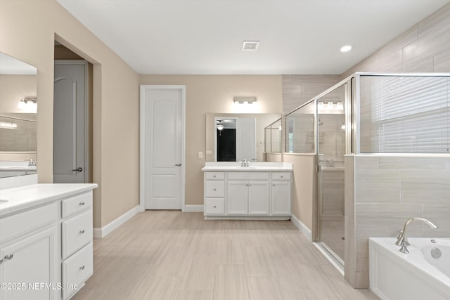 3024 Las Calinas Blvd, Saint Augustine, FL 32095 - full bathroom featuring two vanities, a stall shower, a garden tub, and recessed lighting