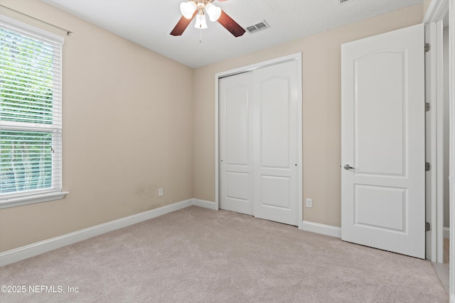 3024 Las Calinas Blvd, Saint Augustine, FL 32095 - unfurnished bedroom featuring carpet, a closet, multiple windows, and ceiling fan