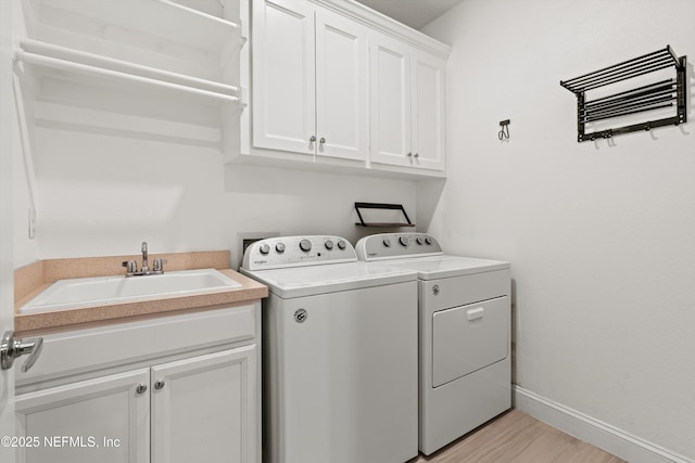 3024 Las Calinas Blvd, Saint Augustine, FL 32095 - washroom with cabinet space, washer and dryer, and light wood finished floors