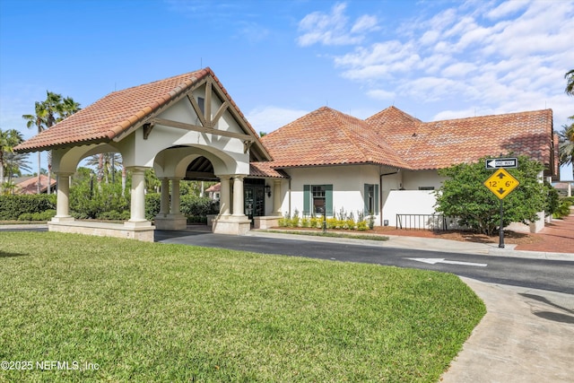 3024 Las Calinas Blvd, Saint Augustine, FL 32095 - view of front facade featuring stucco siding, a tile roof, and a front yard
