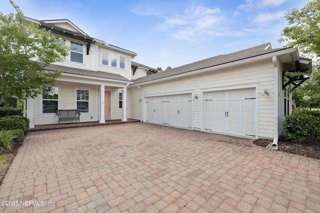 21 Mollusk Rd, Saint Johns, FL 32259 - view of front of property featuring an attached garage, decorative driveway, and covered porch