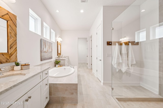 21 Mollusk Rd, Saint Johns, FL 32259 - bathroom featuring two vanities, a garden tub, walk in shower, and recessed lighting
