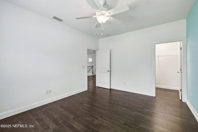 21 Mollusk Rd, Saint Johns, FL 32259 - unfurnished bedroom with dark wood-type flooring, a walk in closet, a ceiling fan, and a closet