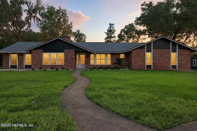 2181 Glenwood Hammock Rd, Deland, FL 32720 - ranch-style home featuring brick siding, a front yard, and a chimney