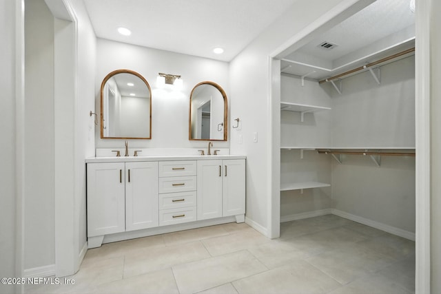 2181 Glenwood Hammock Rd, Deland, FL 32720 - bathroom featuring double vanity, recessed lighting, tile patterned floors, and a spacious closet