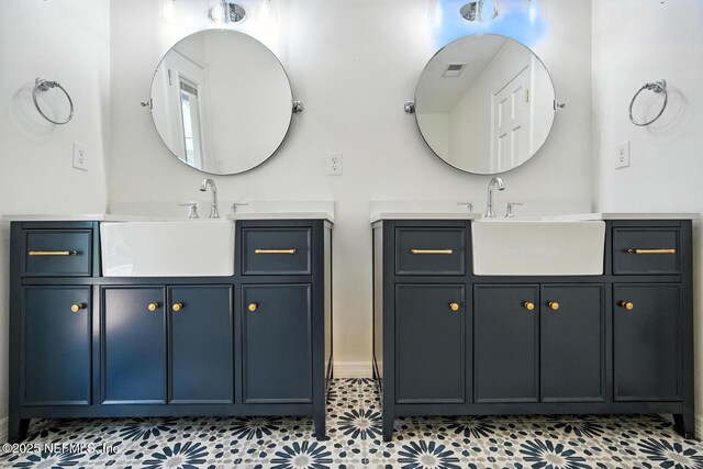 2181 Glenwood Hammock Rd, Deland, FL 32720 - bathroom featuring two vanities and tile patterned flooring