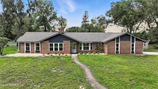 2181 Glenwood Hammock Rd, Deland, FL 32720 - ranch-style home featuring brick siding, a front yard, and a chimney