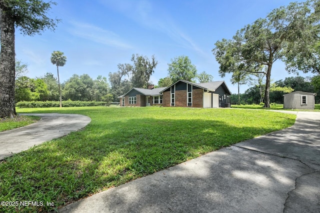 2181 Glenwood Hammock Rd, Deland, FL 32720 - view of front of home featuring brick siding, a chimney, a front lawn, and a storage shed