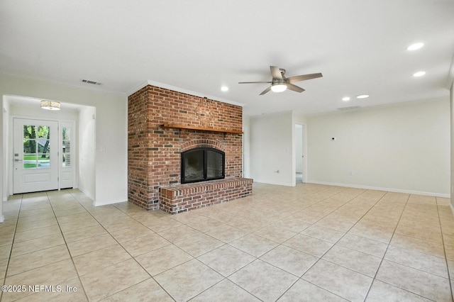 2181 Glenwood Hammock Rd, Deland, FL 32720 - unfurnished living room with light tile patterned flooring, a ceiling fan, recessed lighting, a brick fireplace, and crown molding