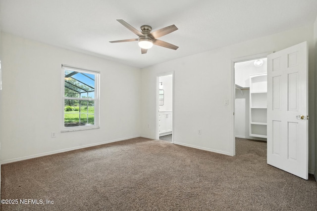 2181 Glenwood Hammock Rd, Deland, FL 32720 - unfurnished bedroom featuring a spacious closet, carpet flooring, ensuite bath, a closet, and a ceiling fan