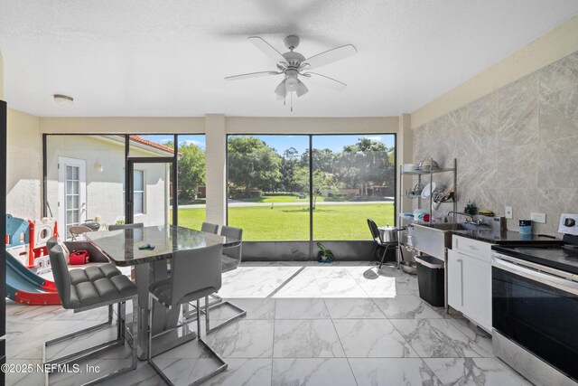 8 Village Cir, Palm Coast, FL 32164 - sunroom / solarium featuring ceiling fan and outdoor dining space