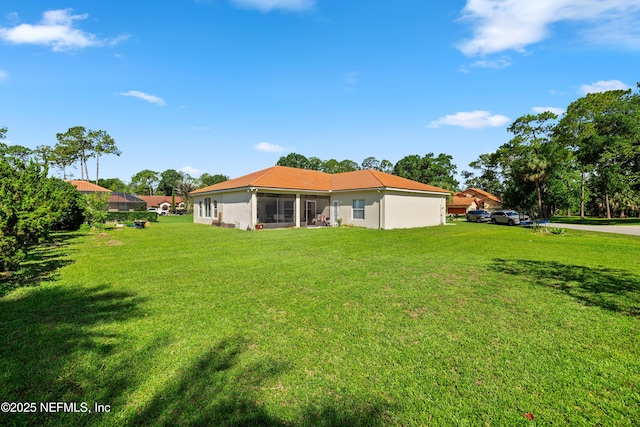 8 Village Cir, Palm Coast, FL 32164 - back of house featuring a lawn and a sunroom