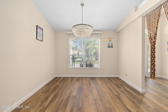 8 Village Cir, Palm Coast, FL 32164 - unfurnished dining area featuring a chandelier and wood finished floors