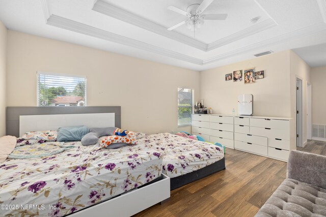 8 Village Cir, Palm Coast, FL 32164 - bedroom with a raised ceiling, ornamental molding, wood finished floors, and multiple windows