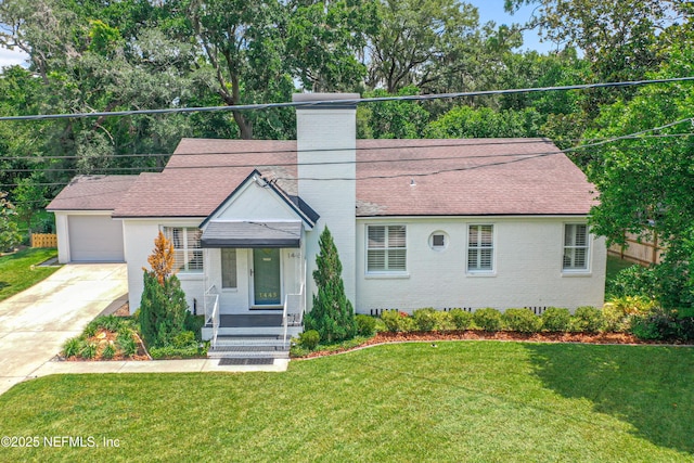 1445 Peachtree St, Jacksonville, FL 32207 - view of front of house featuring brick siding, driveway, a front lawn, a chimney, and roof with shingles