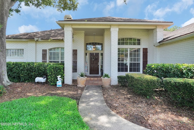 1571 Shelter Cove Dr, Fleming Island, FL 32003 - doorway to property featuring brick siding and a shingled roof