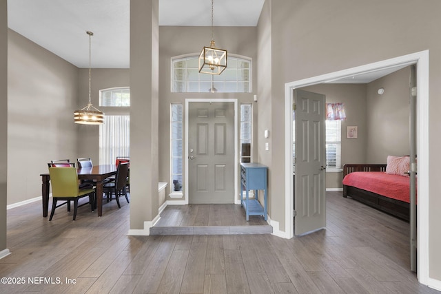 1571 Shelter Cove Dr, Fleming Island, FL 32003 - foyer with a chandelier, a high ceiling, and wood finished floors