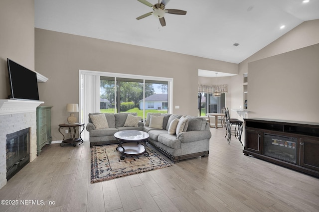 1571 Shelter Cove Dr, Fleming Island, FL 32003 - living area with a fireplace, high vaulted ceiling, ceiling fan, light wood finished floors, and recessed lighting