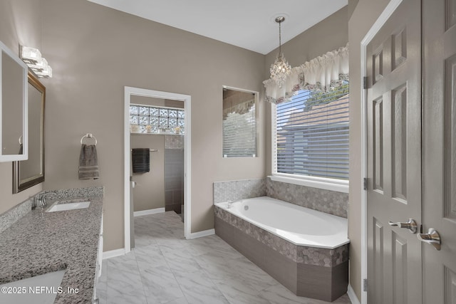 1571 Shelter Cove Dr, Fleming Island, FL 32003 - full bath featuring a garden tub, marble finish flooring, vanity, and a chandelier