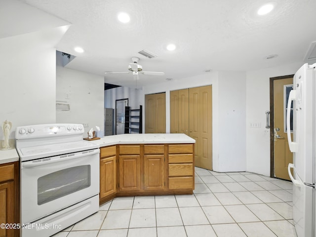150 Calle Menendez, Saint Augustine, FL 32086 - kitchen featuring white appliances, light countertops, recessed lighting, brown cabinetry, and ceiling fan