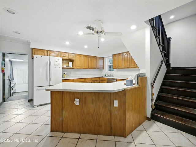 150 Calle Menendez, Saint Augustine, FL 32086 - kitchen featuring freestanding refrigerator, a peninsula, recessed lighting, a ceiling fan, and light countertops
