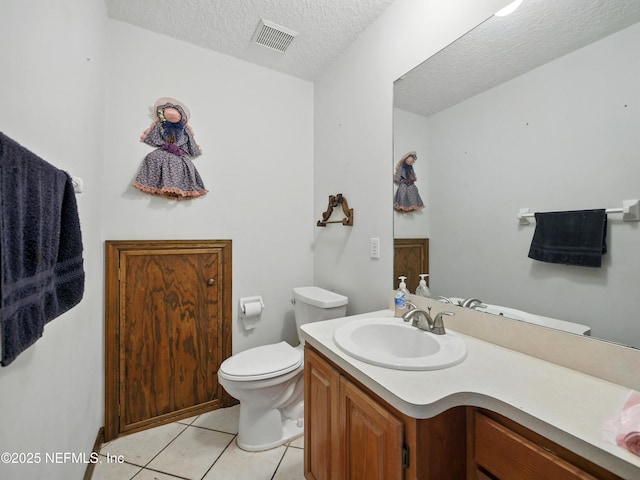 150 Calle Menendez, Saint Augustine, FL 32086 - bathroom featuring vanity, tile patterned flooring, and a textured ceiling