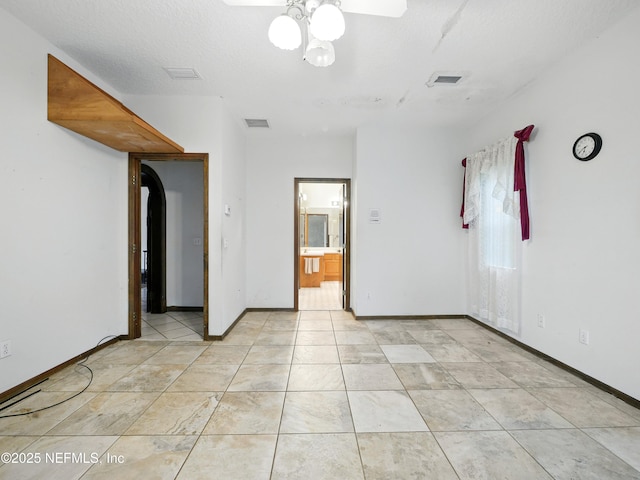 150 Calle Menendez, Saint Augustine, FL 32086 - empty room with a ceiling fan and arched walkways