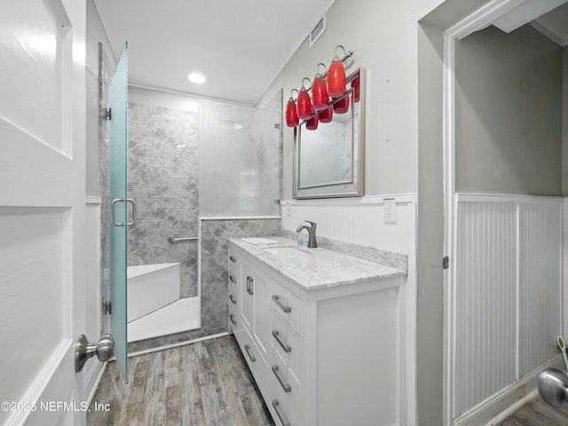 150 Calle Menendez, Saint Augustine, FL 32086 - bathroom featuring wood finished floors, vanity, a stall shower, and a wainscoted wall