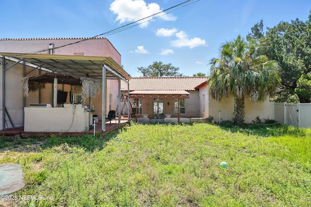 150 Calle Menendez, Saint Augustine, FL 32086 - rear view of house with stucco siding, a tile roof, and a patio area