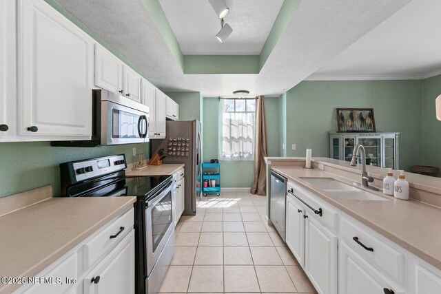 10075 Gate Pkwy N Unit 913, Jacksonville, FL 32246 - kitchen featuring stainless steel appliances, white cabinets, light countertops, light tile patterned floors, and a textured ceiling