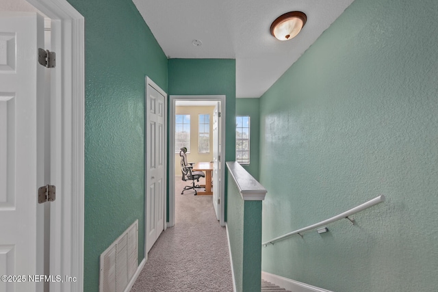 10075 Gate Pkwy N Unit 913, Jacksonville, FL 32246 - hallway featuring a textured wall and carpet floors