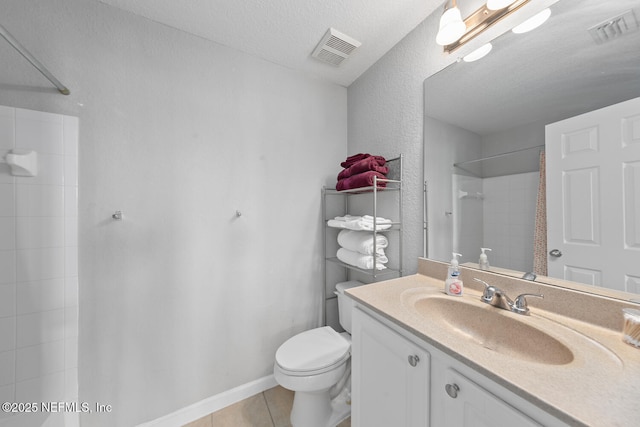 10075 Gate Pkwy N Unit 913, Jacksonville, FL 32246 - bathroom featuring vanity, a shower, tile patterned flooring, and a textured ceiling