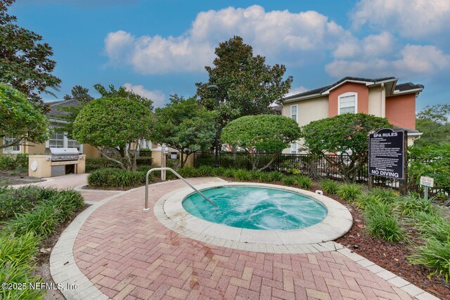 10075 Gate Pkwy N Unit 913, Jacksonville, FL 32246 - view of pool featuring a hot tub